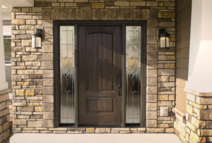 A drk wood entry door with sidelites
