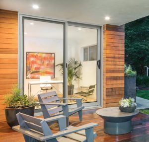 Sliding glass doors leading to a wood deck