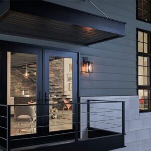 Residential property with a balcony, French doors, and dark-colored steel siding.