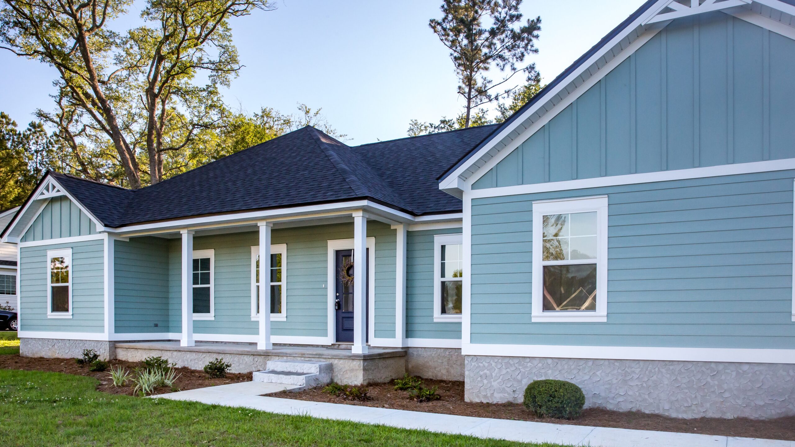 A home with blue vinyl siding and white trim