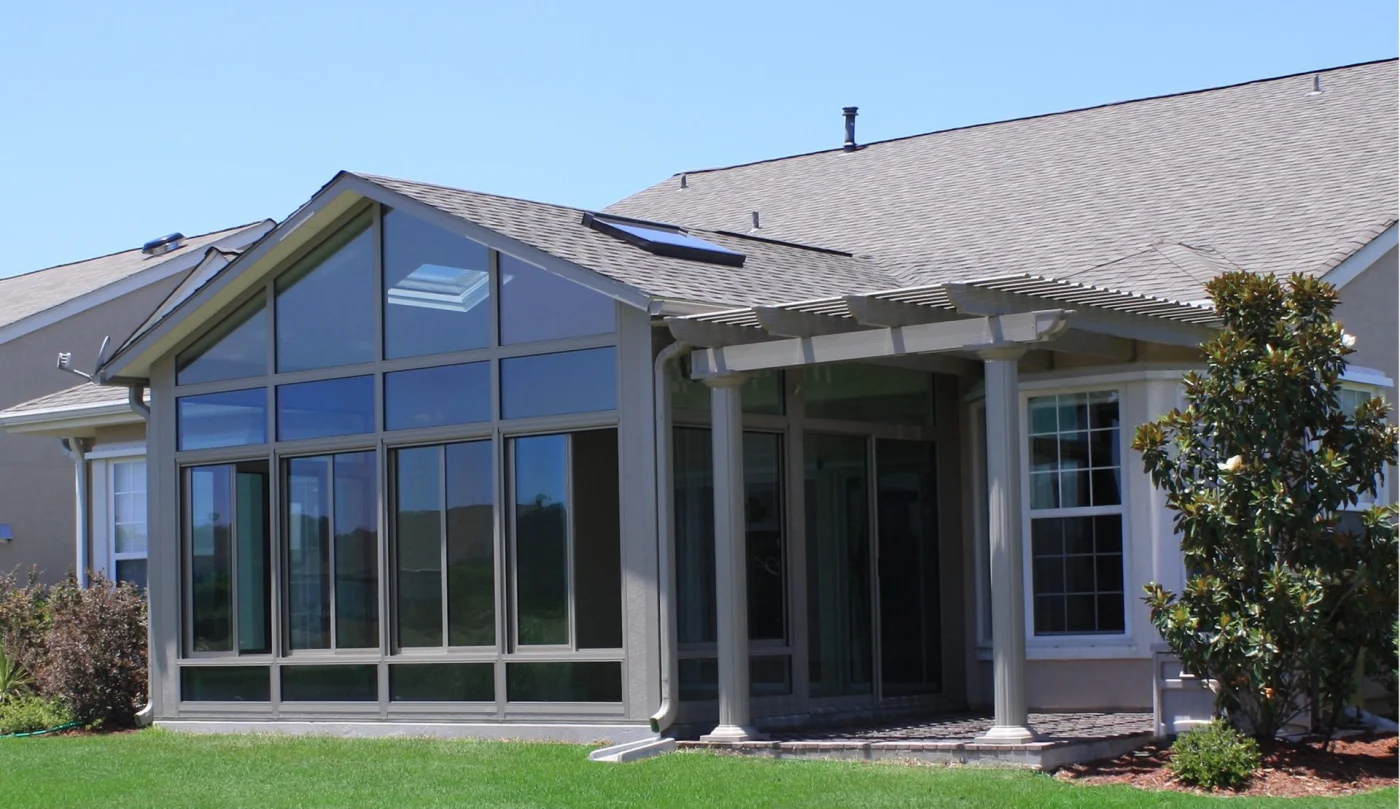 Residential home with dark siding and a brown front entry door